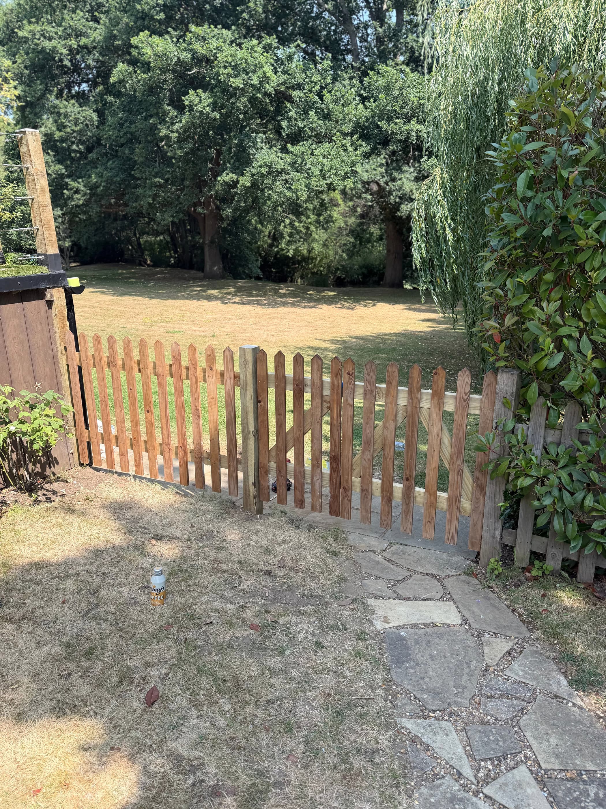The completed picket fence and gate in the same position once finished