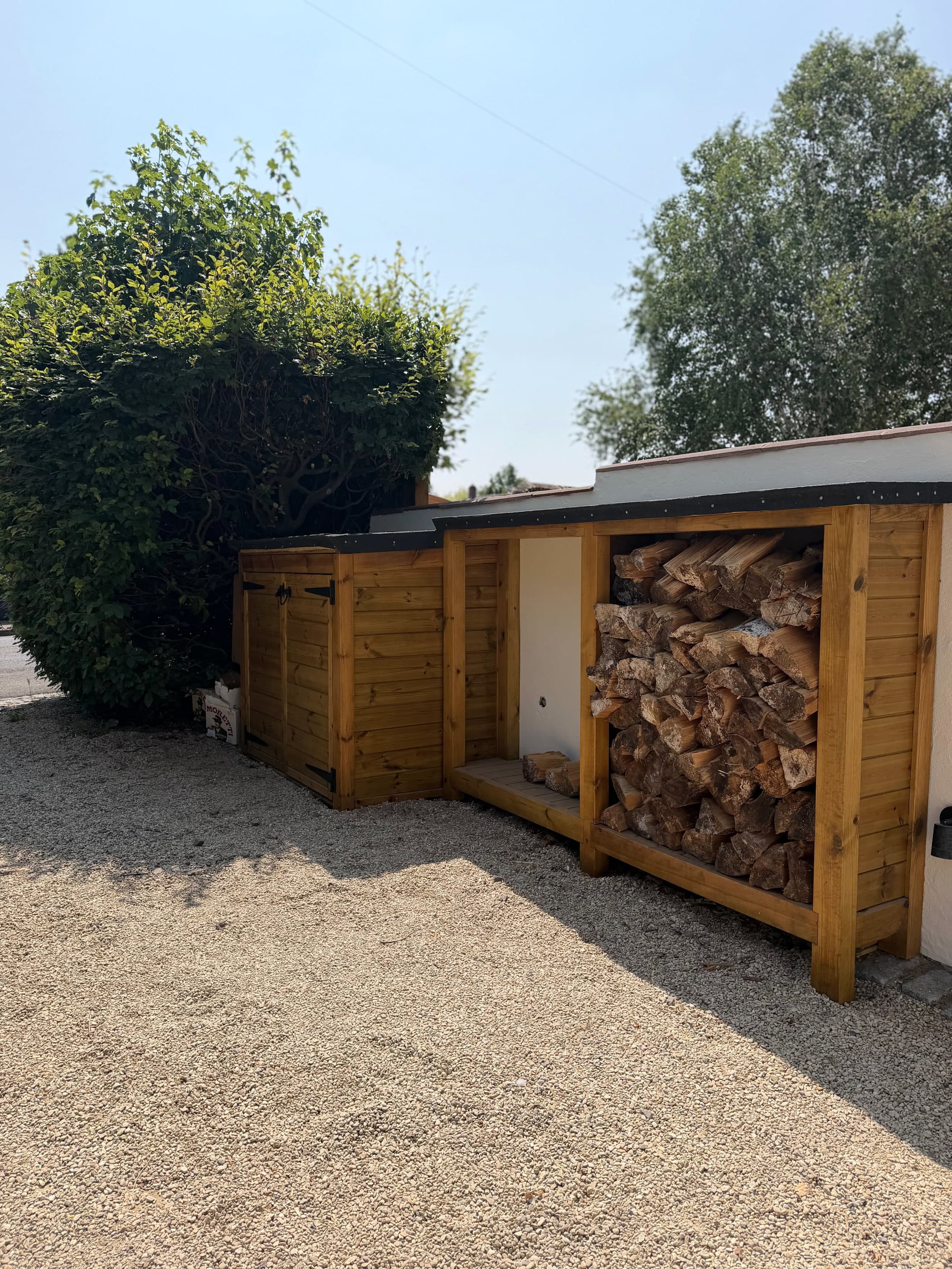 Bespoke timber log store and bin store in a Surrey garden