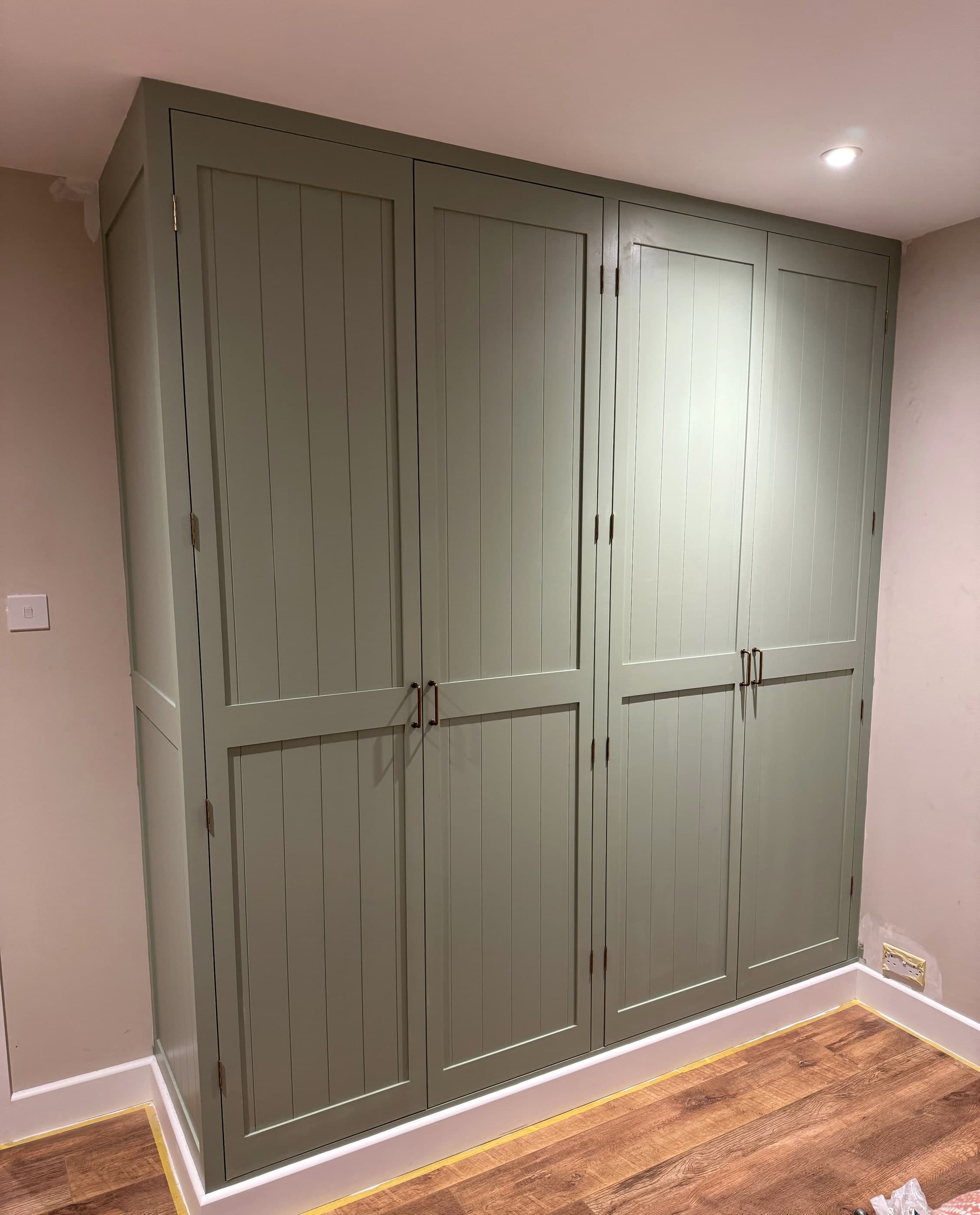 Close view of the shaker-framed, tongue-and-groove doors on a bespoke fitted wardrobe